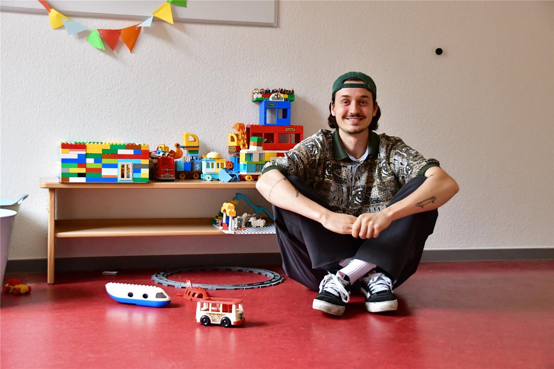 Jan Johannes, dualer Student, sitzt auf dem Boden in einer Wohngruppe der Münze.